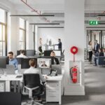 Modern office with fire safety equipment emphasizing compliance and safety